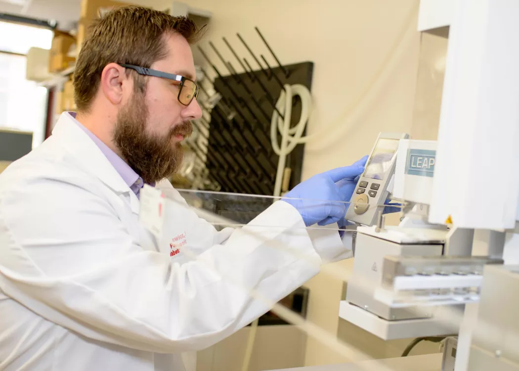 Researcher Pawel Lorkiewicz working a lab. He established methods for detecting and quantifying urinary metabolites of VOCs which are used in the human and wastewater studies for VOC exposure.