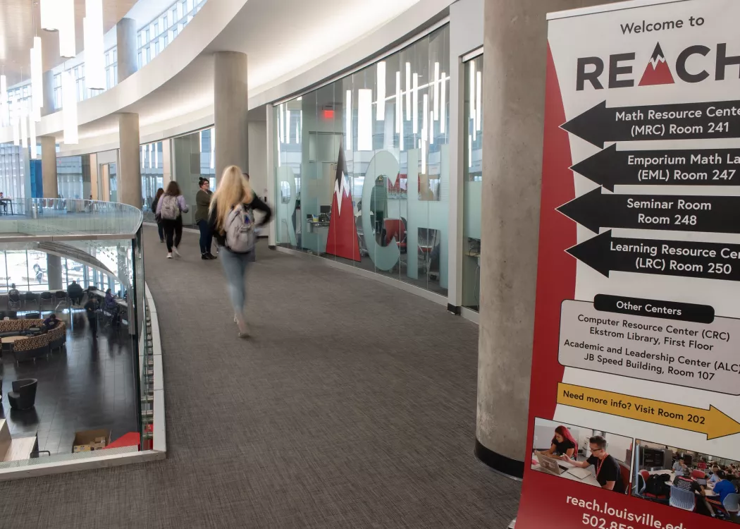 Students walking down the hallway near the REACH offices in the Belknap Academic Building