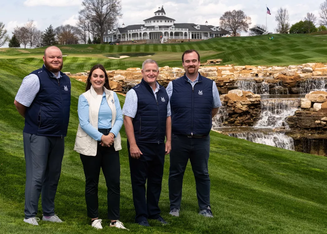 3 men and a woman on a golf course