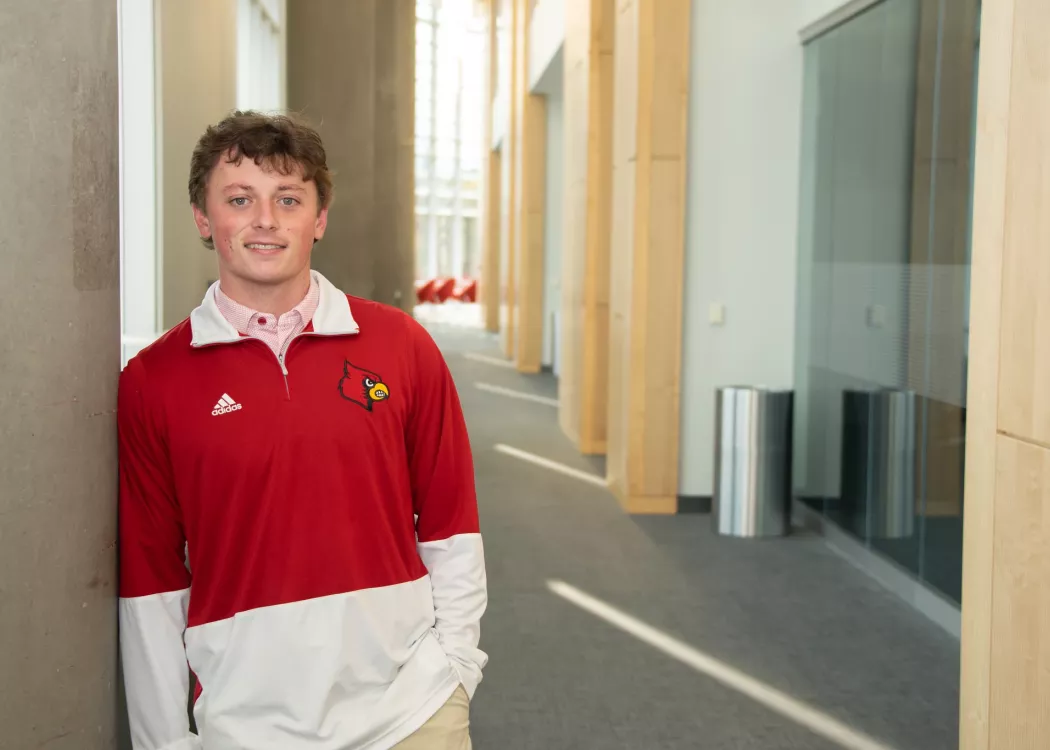 James Walls smiles will wearing a UofL sweatshirt