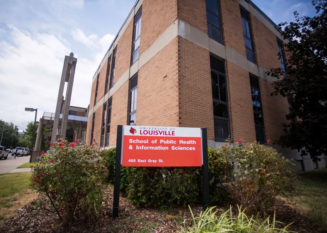 red and white sign in front of building that says University of Louisville School of Public Health and Information Sciences, 485 E. Gray St.