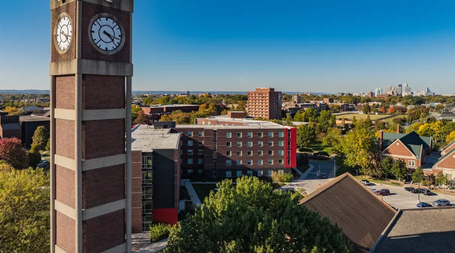 High angle shot of the Student Activities Center clock tower with downtown Louisville in the distance